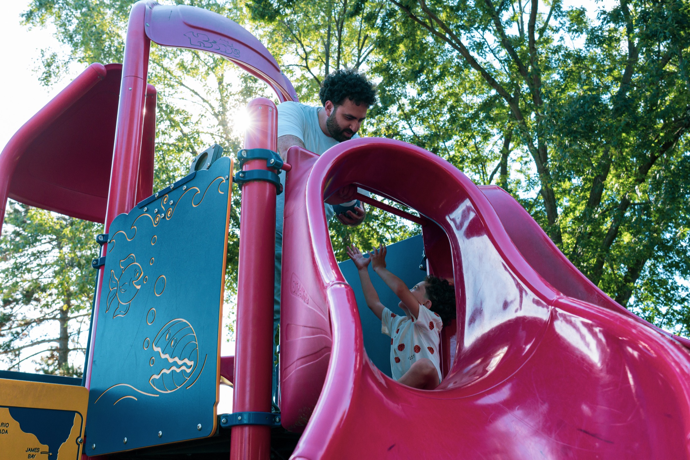 Jad El Ghali helping a child at a Mississauga playground